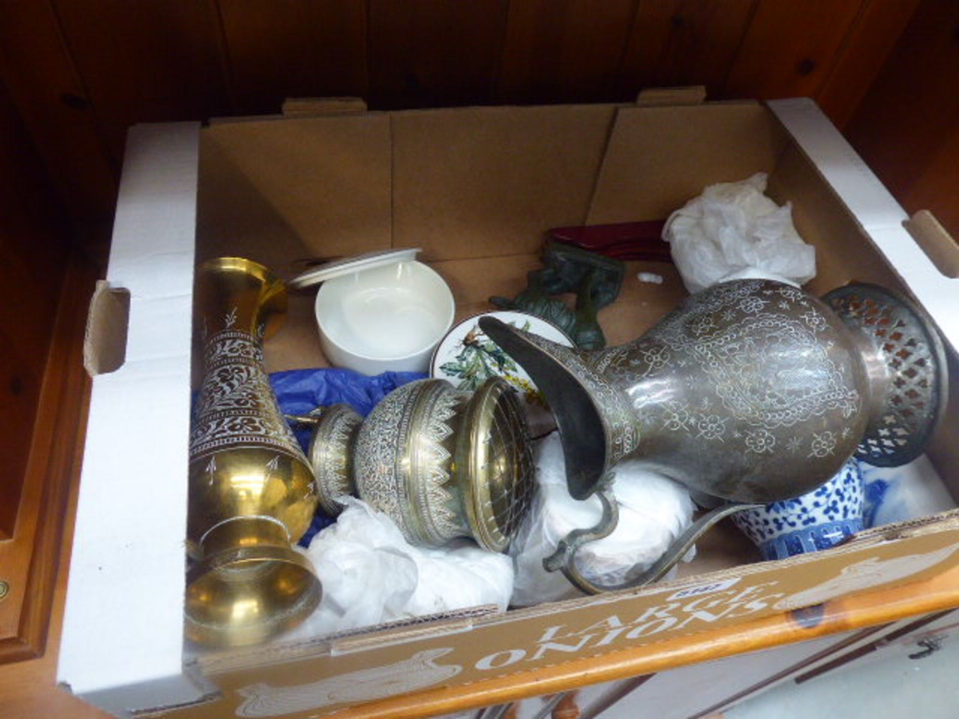 Box containing brass bowls and vases plus a jug, tang style horse, blue and white crockery and plant