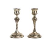 A pair of early 20th century silver dwarf candlesticks of slender form, maker S&Co.