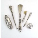 Six early 20th century silver mounted and repousse decorated dressing table items including a