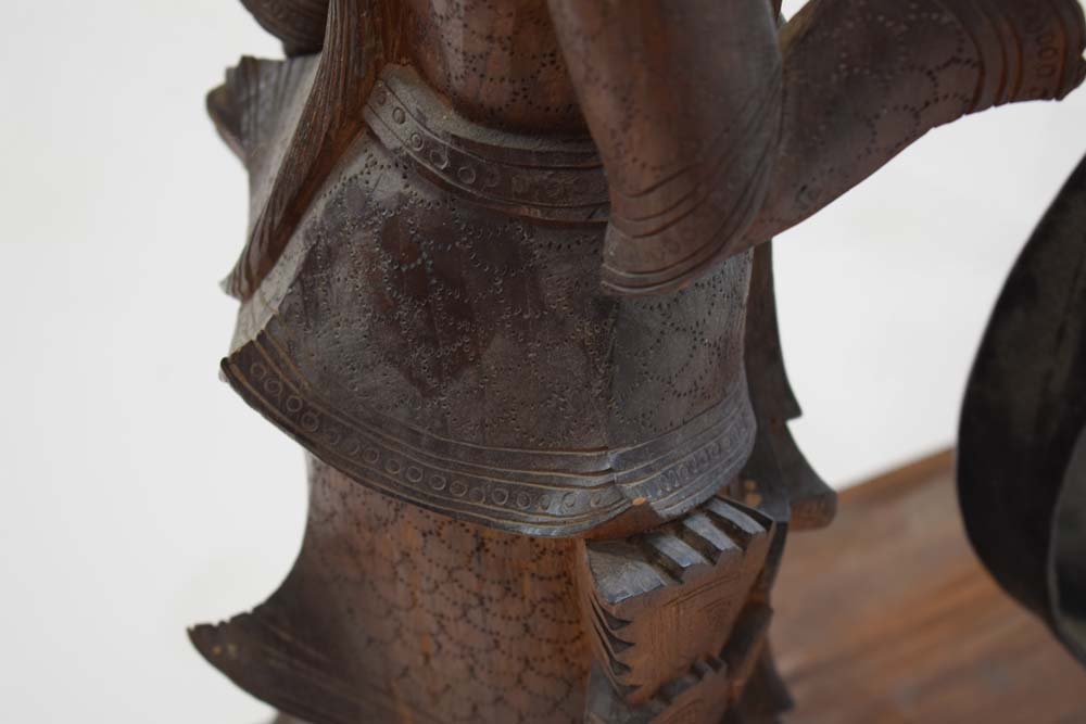 A Tibetan metal gong suspended on a pair of wooden standing figures CONDITION REPORT: - Image 4 of 8