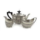 A bachelors silver three piece tea service of vase shaped form with gadrooned decoration,