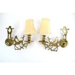 A pair of brass figural wall sconces modelled as prancing horses