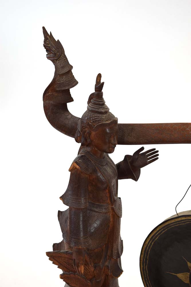 A Tibetan metal gong suspended on a pair of wooden standing figures CONDITION REPORT: - Image 3 of 8