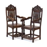 A pair of armchairs decorated in the Oriental manner with pierce work motifs and figures and