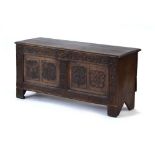 A late 17th/early 18th century and later oak coffer with a panelled front and carved stiles, l.
