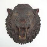 A gilt and overpainted plaster wall plaque modelled as a roaring lion, h.