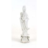 A Chinese blanc de chine figure on a lotus flower base, h. 20.