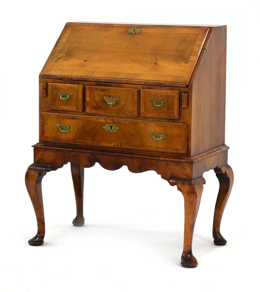 An early 18th century and later walnut bureau on stand,