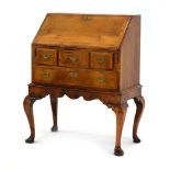 An early 18th century and later walnut bureau on stand,