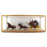 A plastic kit built Wells Fargo overland stagecoach, cased, case w. 92.