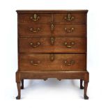 A Georgian oak chest-on-stand, one of the two short drawers with an interior fitted for cutlery,