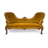 A Victorian Rococo mahogany and button upholstered sofa on scrolled acanthus capped front legs