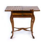 An early Victorian burr walnut games table, the folding games surface over a drawer and slide,