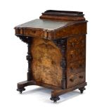 A Victorian figured walnut Davenport with cushion shaped stationary drawer and hinged writing