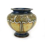 A Royal Doulton vase of squat vase shaped form decorated with shield shaped fields in shades of