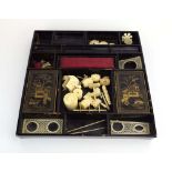 A 19th century chinoiserie sewing tray containing bone fitments including a needle holder,