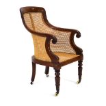 A 19th century mahogany and bergere armchair on turned front legs with castors CONDITION