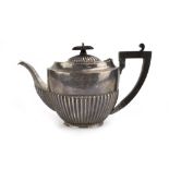 An early 20th century silver teapot of vase shaped form with gadrooned decoration, maker TW,