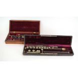 A late 19th/early 20th century rosewood flute by Laube together with another by Keith Prowse in a