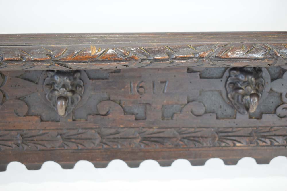 A carved oak hall shelf with figural flanks and four mask head hooks, - Image 4 of 4