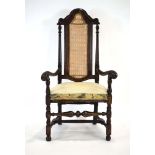 An early 18th century-type walnut and beech library chair with a caned back