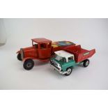 A mid century red Tri-ang tinplate lorry containing building bricks and a later Tri-ang Hi-Way