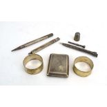 A mixed parcel of silver comprising two pencils, a pair of engine turned napkin rings,