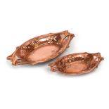 A pair of Art Nouveau copper finished graduated dishes, max. l.