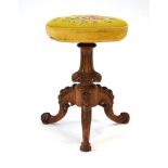 A Victorian adjustable piano stool with an upholstered seatm mahogany carved column and three