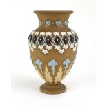 A Doulton Lambeth Silicon ware vase of urn shaped form typically relief decorated with flowerheads