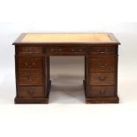 A Victorian mahogany and tooled leather twin-pedestal desk with an arrangement of nine drawers on