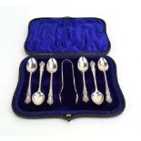 A cased set of six Edwardian silver teaspoons and a pair of matching sugar nips in the Rococo
