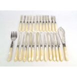 A set of twelve Victorian silver and mother of pearl handled cake knives and forks, maker WH,