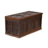 A 20th century oak and panelled coffer decorated with carved foliate carvings throughout, l.