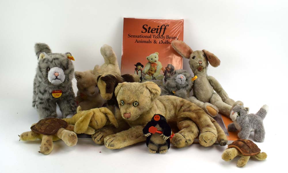 Four modern Steiff plush animals, each modelled as a cat, together with a seated tiger, two rabbits,