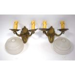 A pair of Art Deco brass twin-branch wall lights together with two ribbed glass shades