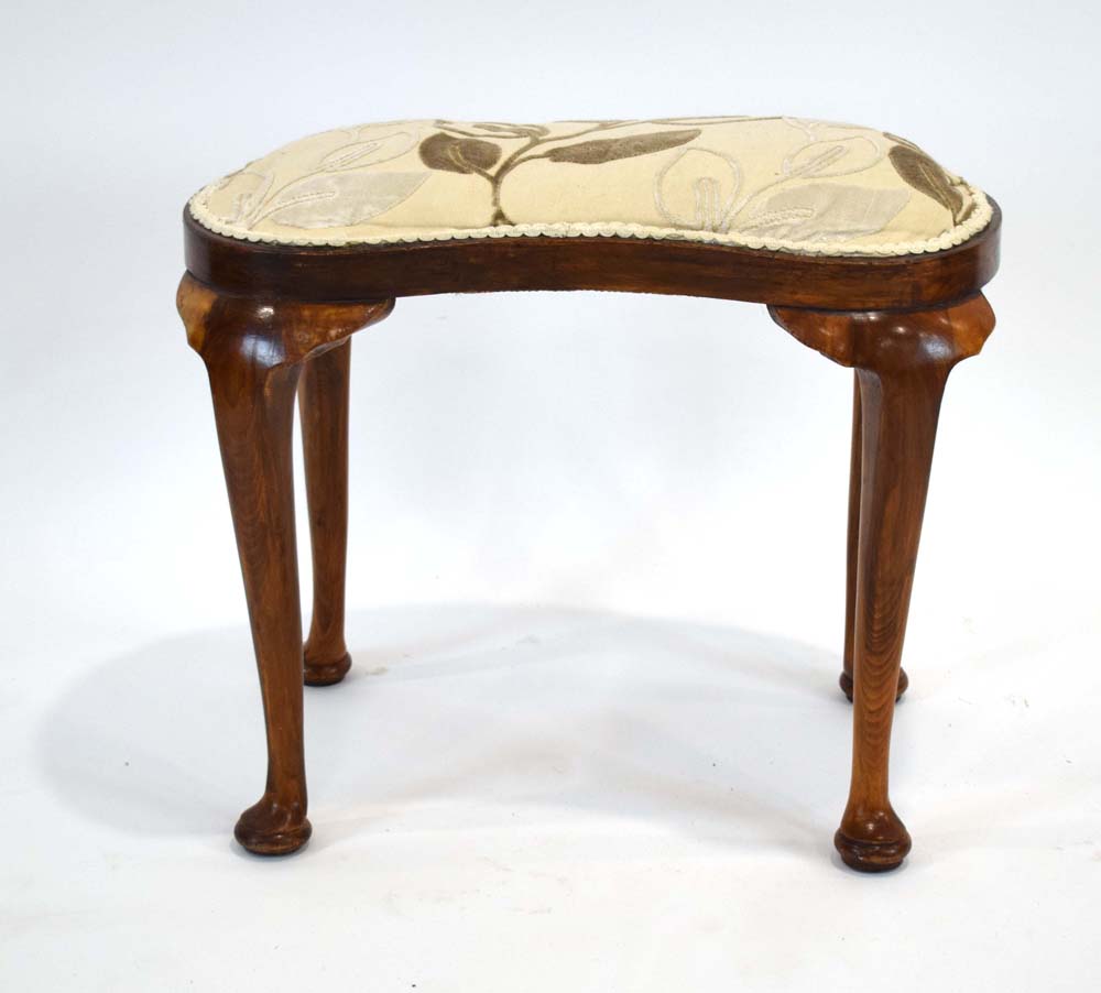 A Georgian-style beech and upholstered kidney shaped dressing stool