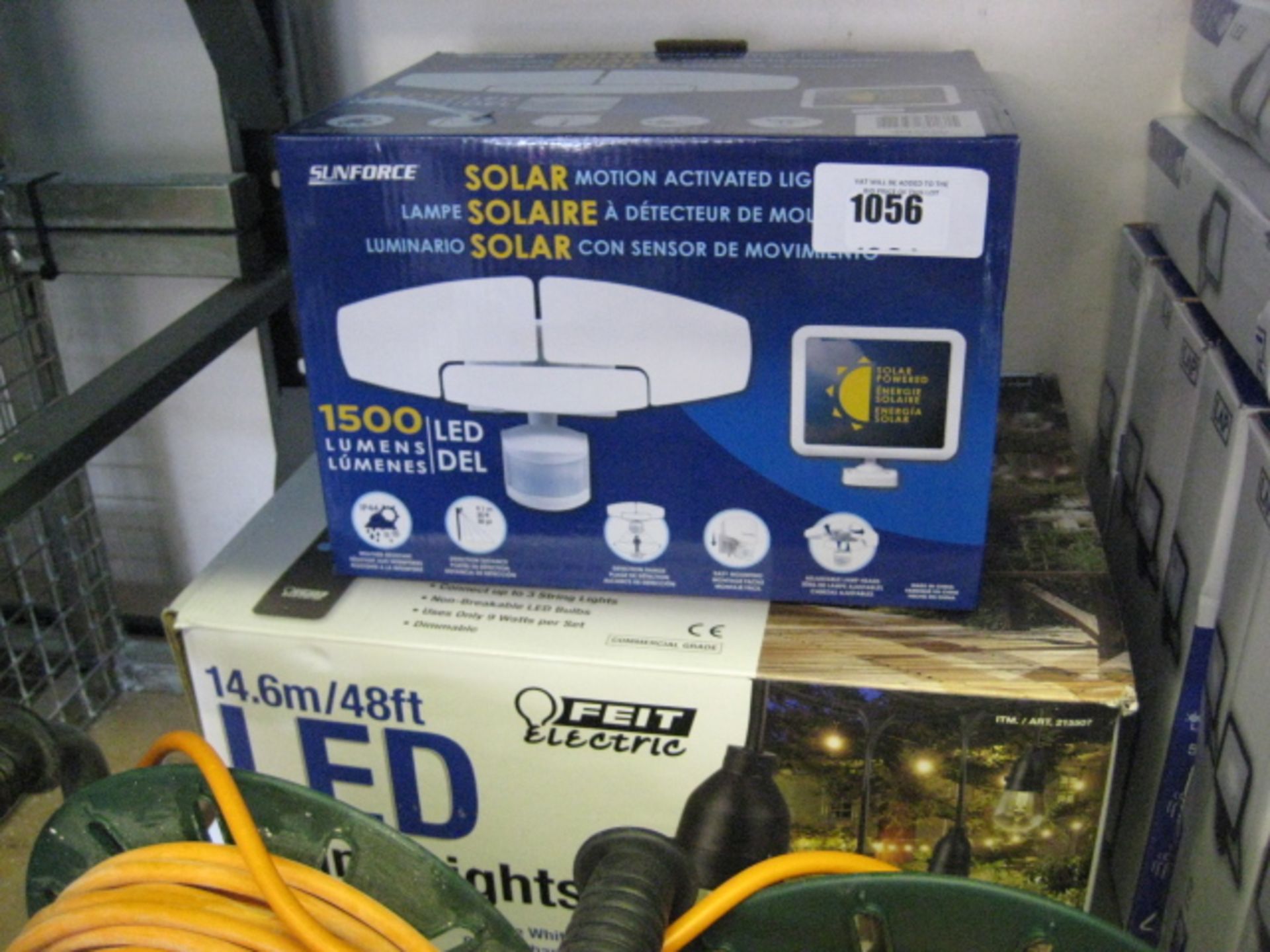 Boxed Sunforce solar motion activated light with box of LED string lights