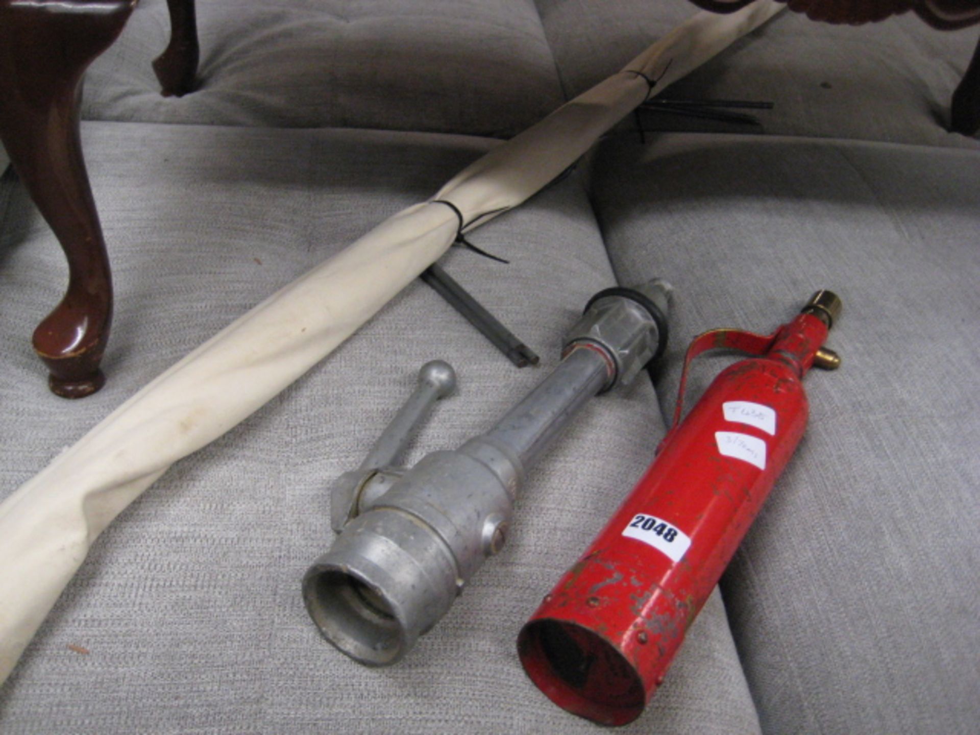 Vintage fire extinguisher, pump handle and camp bed frame