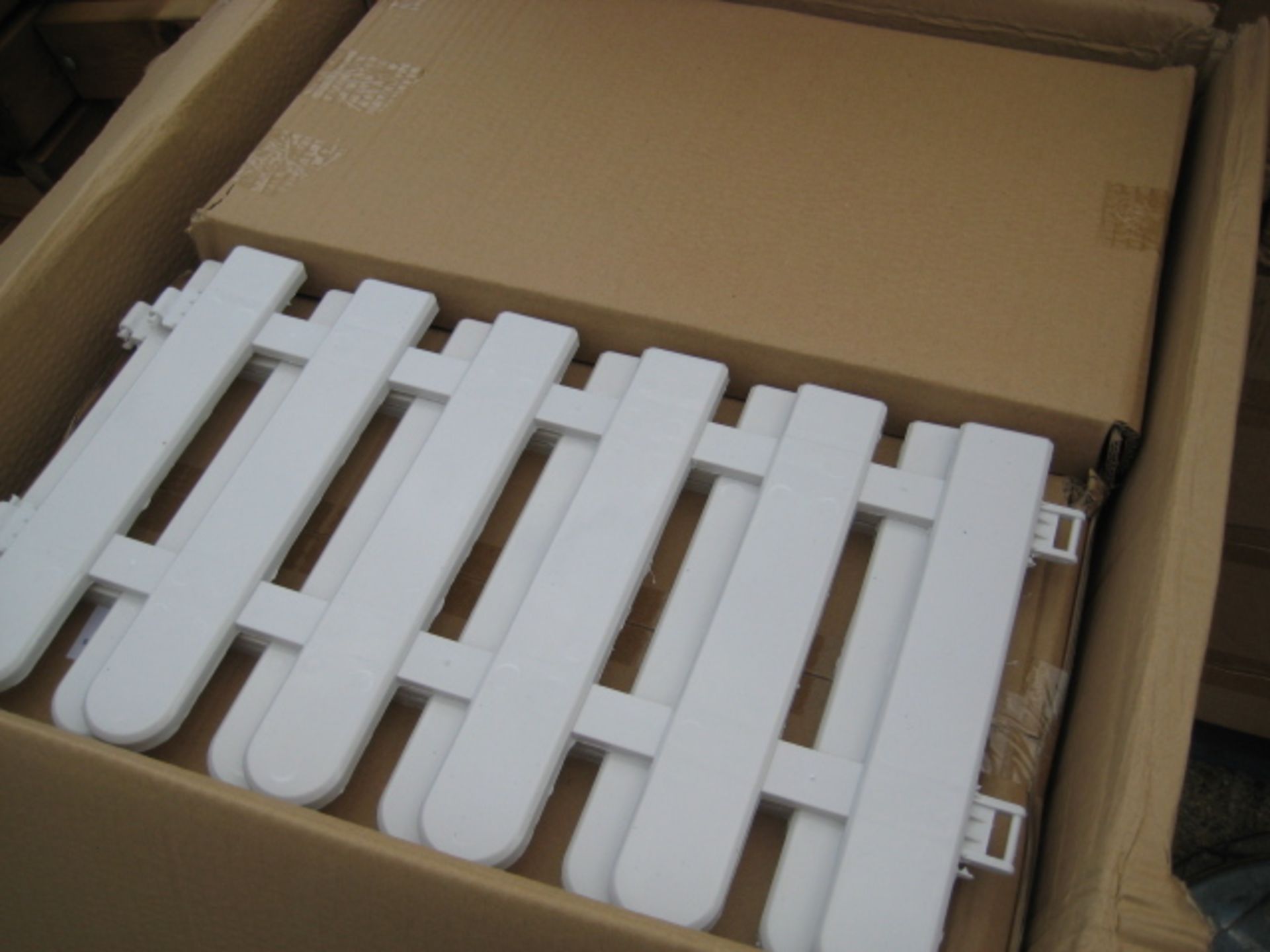 Box containing 3 sets of interlocking plastic picket fence in white