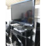 (5) Panasonic flat screen TV with Panasonic DVD player and 3 tier glass TV stand