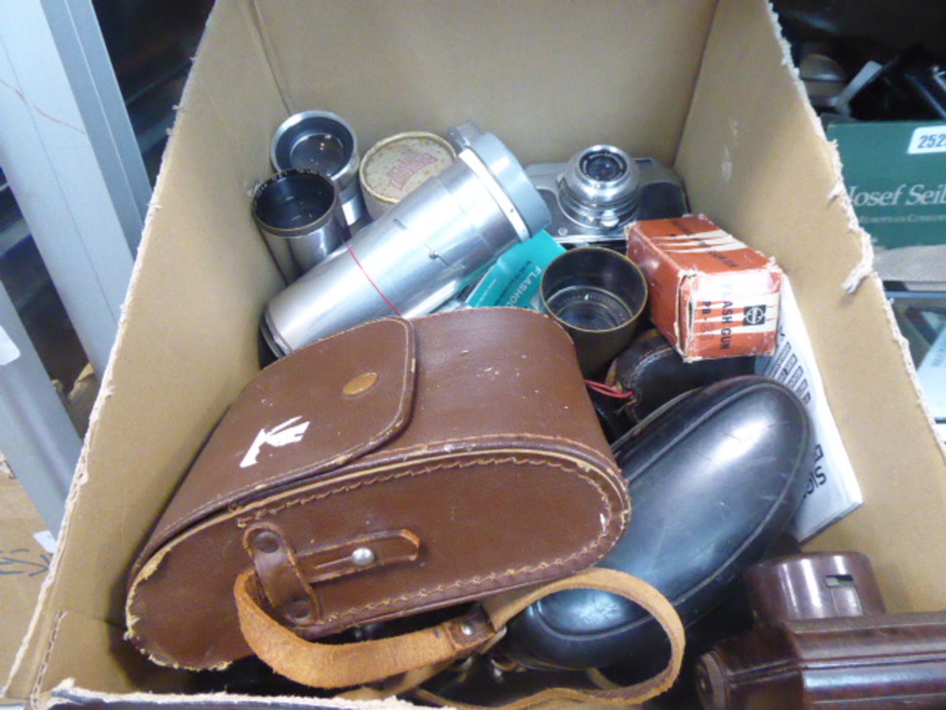 Box containing vintage film camera equipment
