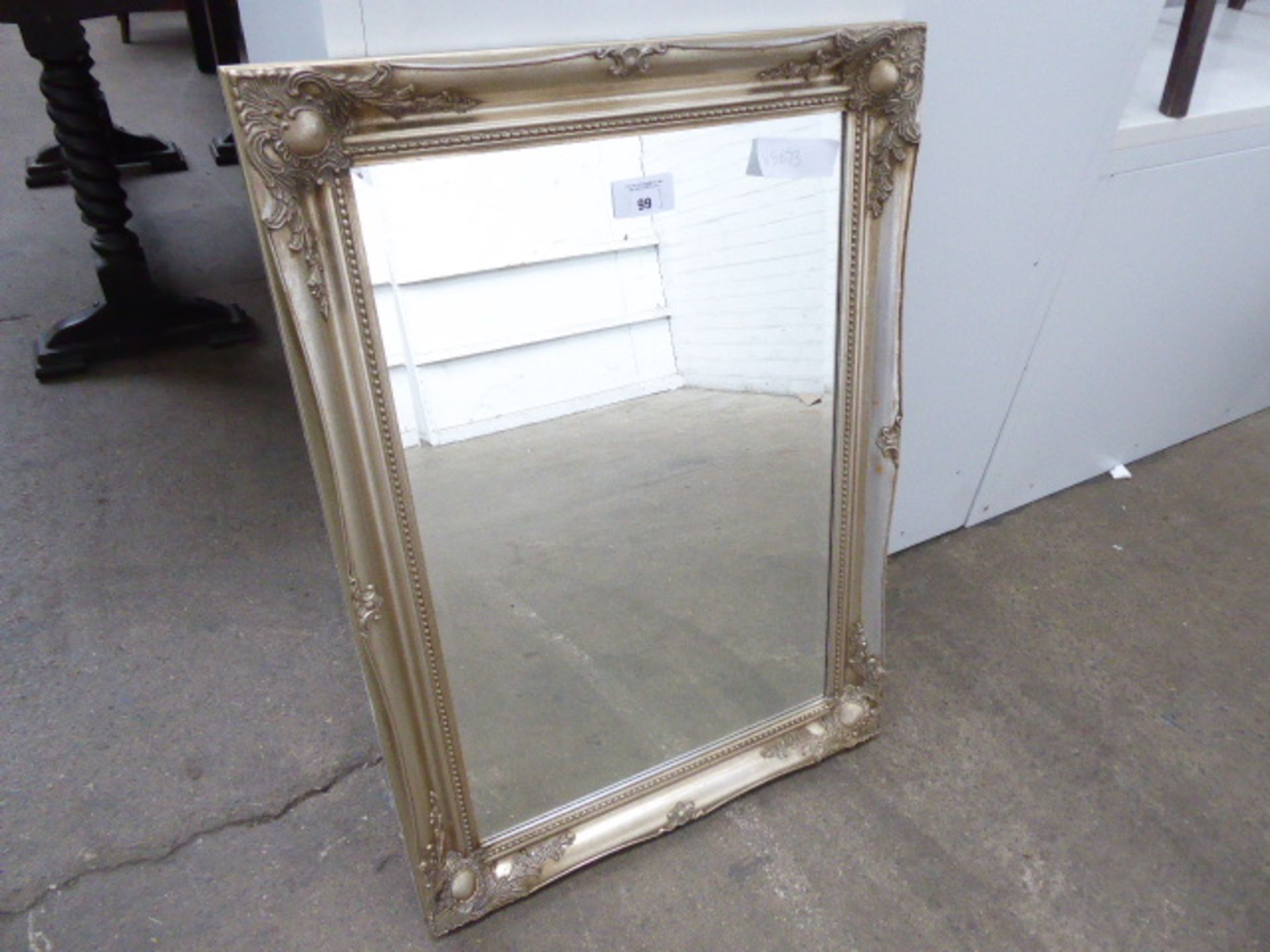 Ornate framed bevelled mirror