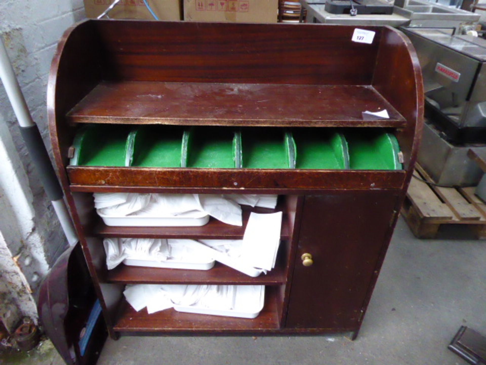 A mahogany effect 90cm wide dumbwaiter with some disposable napkins