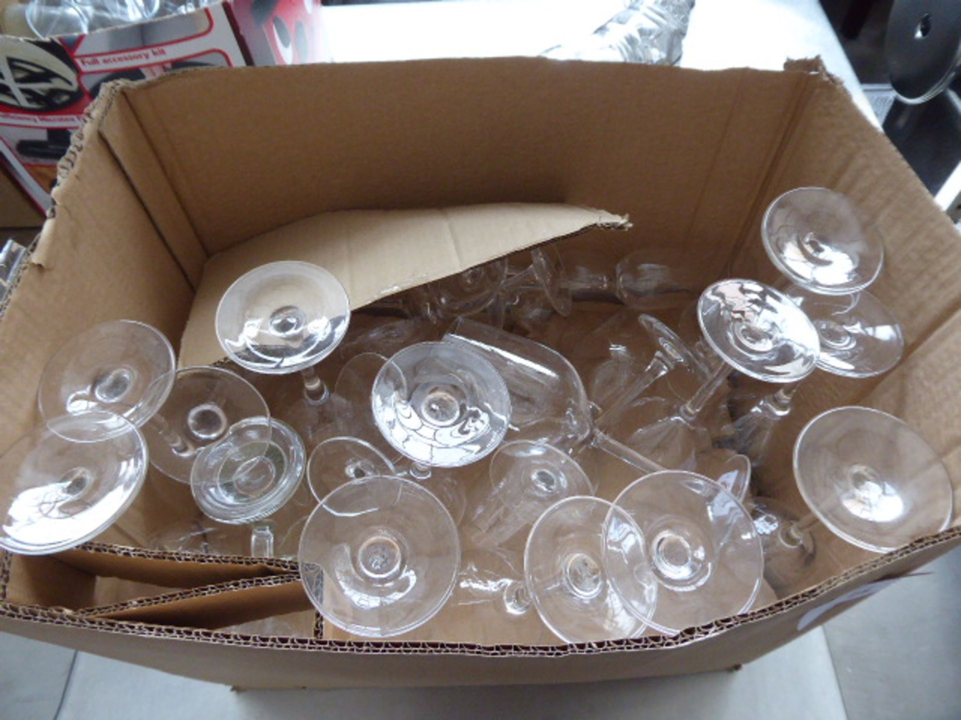 Large cardboard box containing assorted glassware