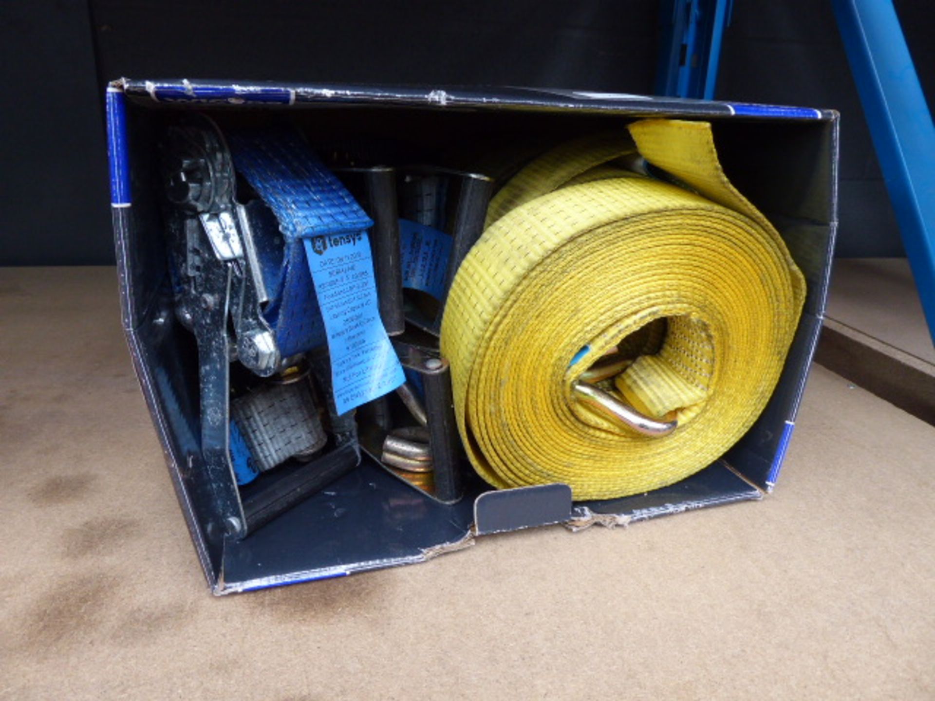 Box of assorted blue and yellow ratchet straps