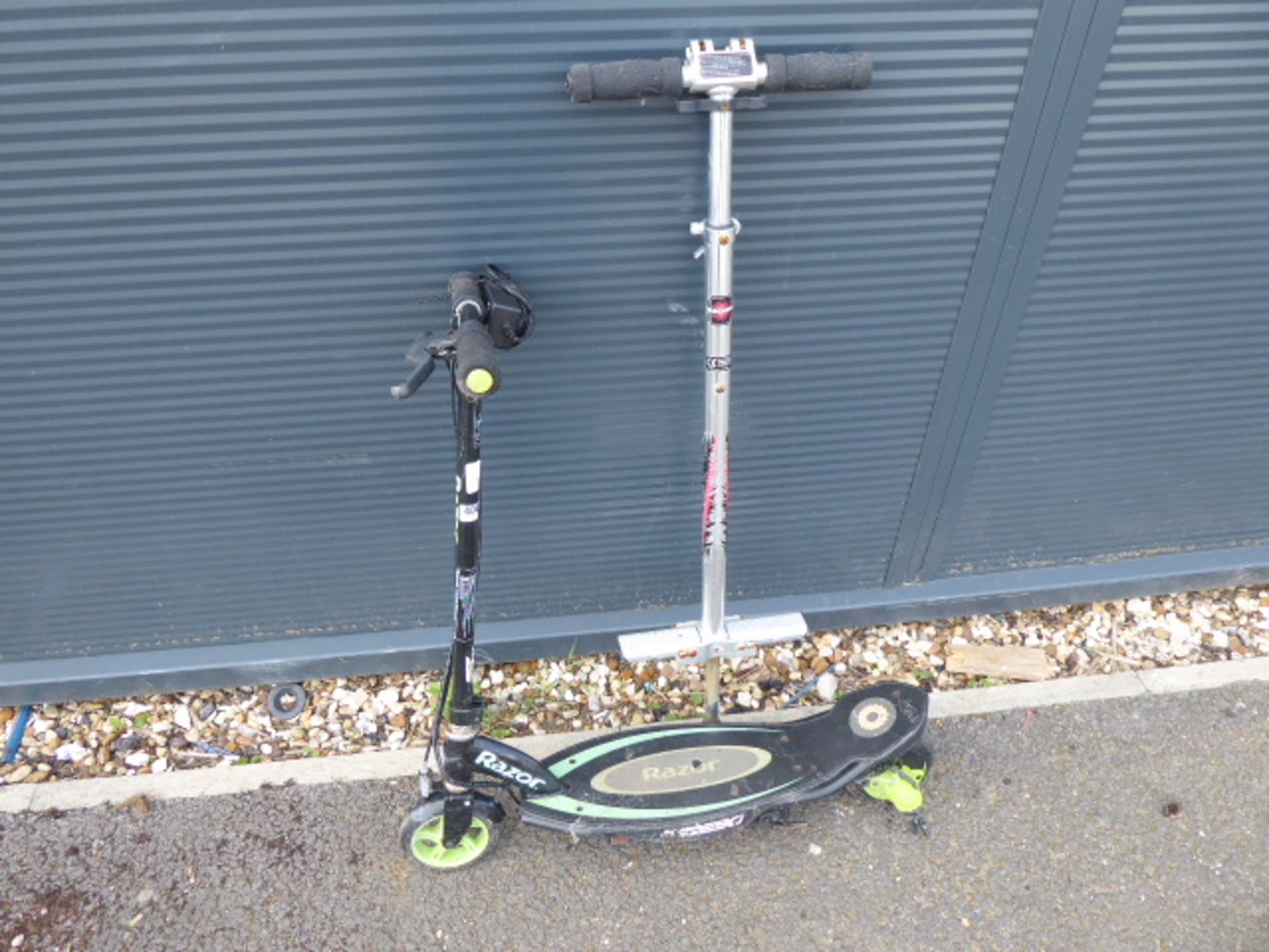 Small green and black Razor electric scooter and pogo stick