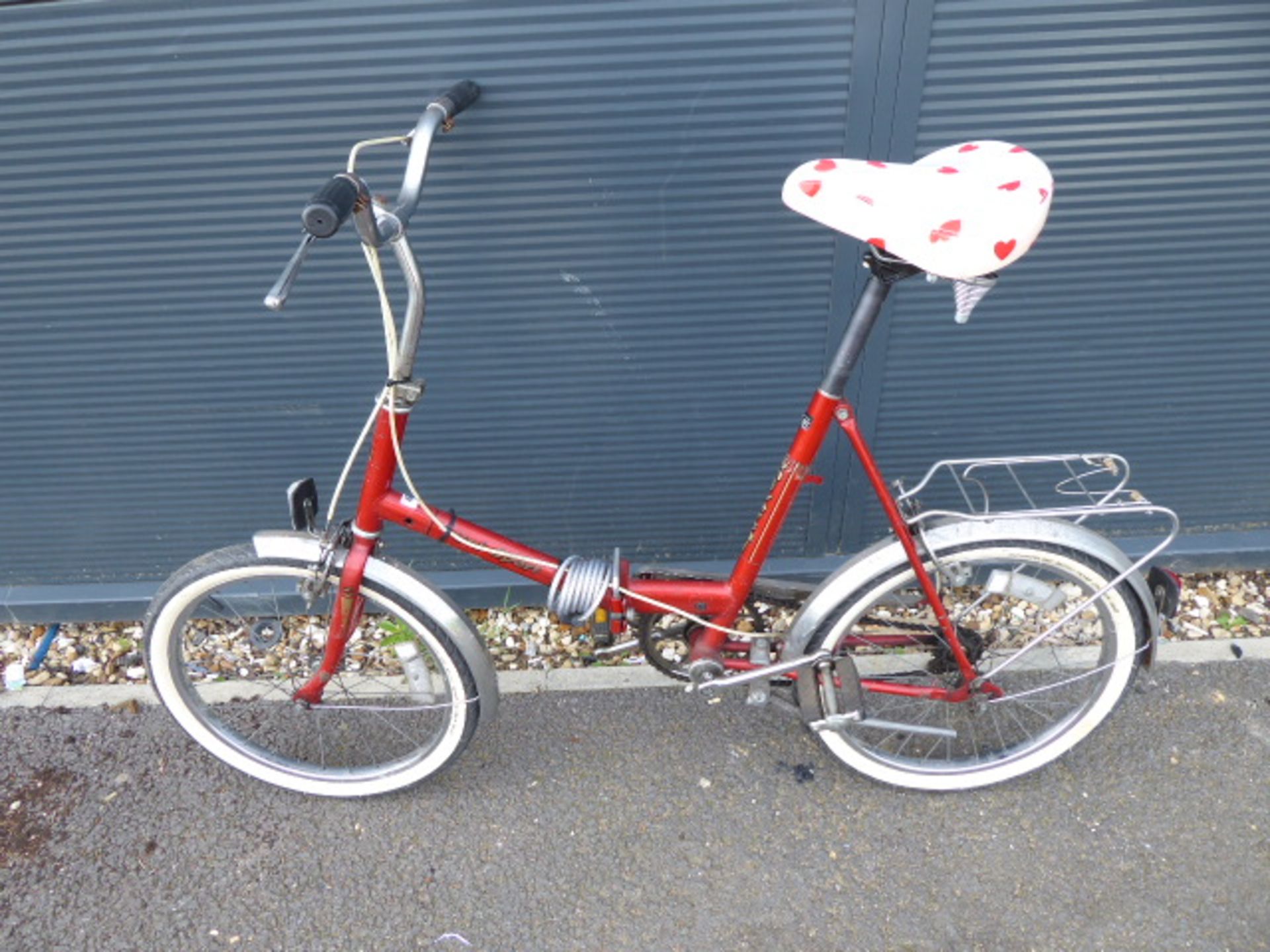 Red vintage ladies folding cycle with love heart saddle