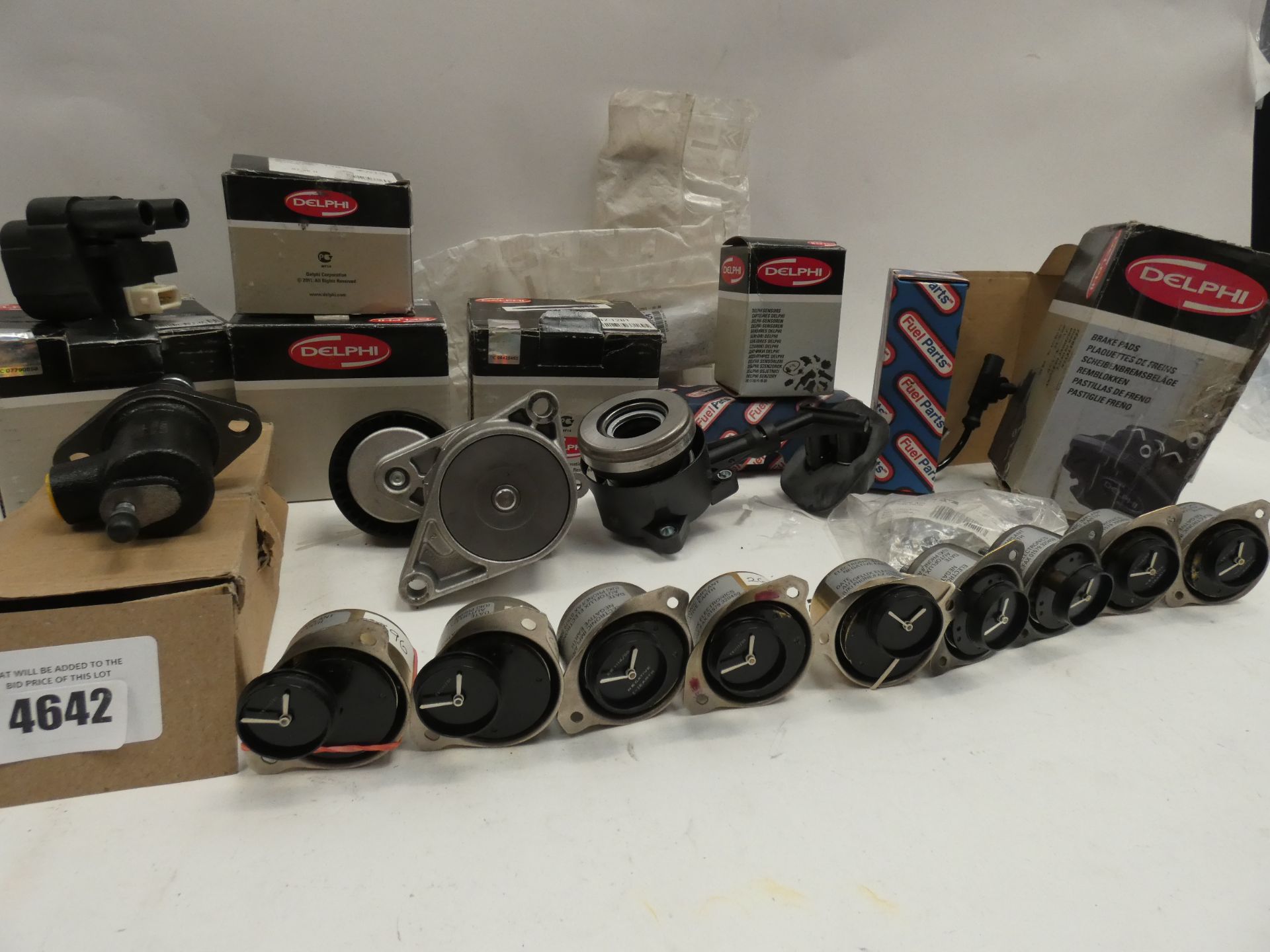 A selection of automotive parts including electronic clocks, Delphi pads and parts, clutch slave,