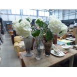 3 glass vases containing artificial flowers